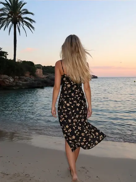 User walking barefoot on the beach at sunset, shown as an AI color analysis preview for hair tone matching.