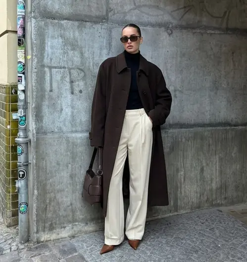 User in a dark overcoat and cream trousers, styled with undertone-matched colors from AI color analysis.