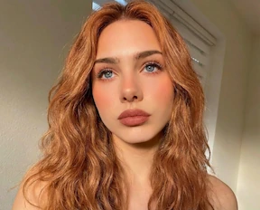 Strawberry Blonde hair color virtual try-on result on long wavy hair using AI hair color changer.