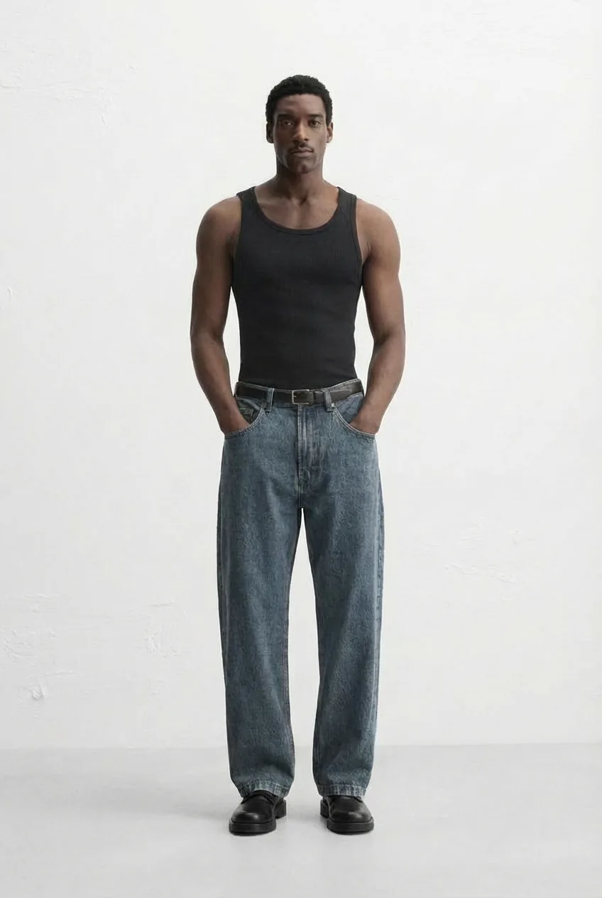 Black man model in a black tank top and blue jeans, for virtual try-on with the AI outfit generator.